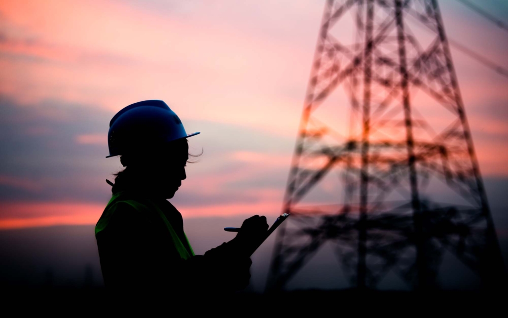 Silhouette of engineer working on sunset